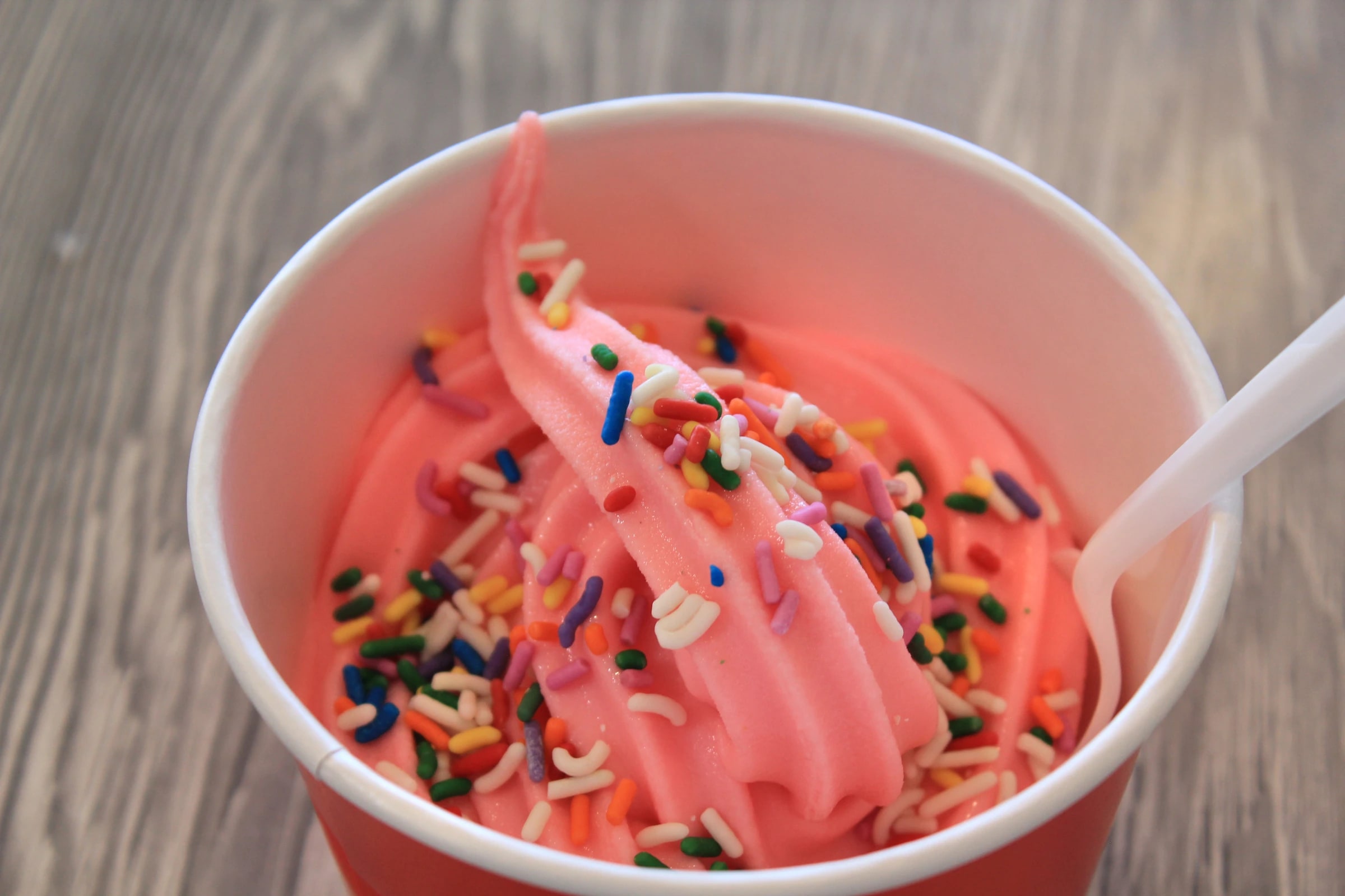 Pink frozen yogurt with colorful sprinkles at ROY’S